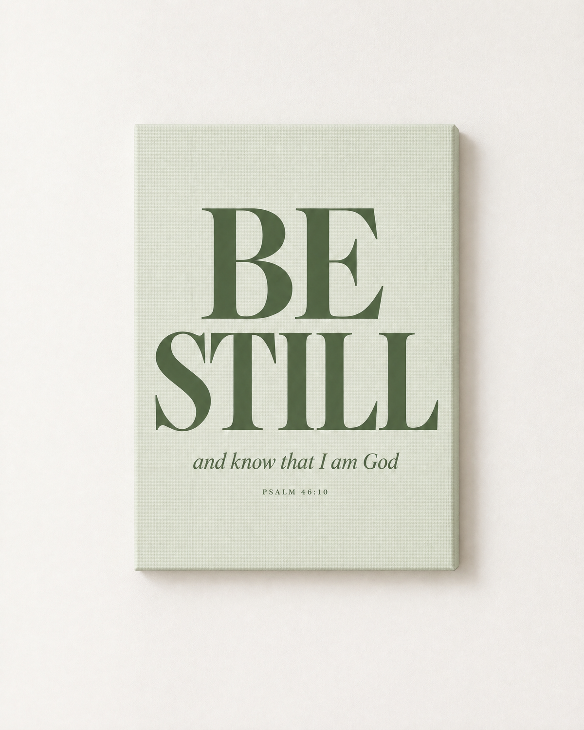 Be Still: Sage print as a gallery-wrapped canvas on a white wall, reading “Be still, and know that I am God” (Psalm 46:10, KJV). Digital mockup.