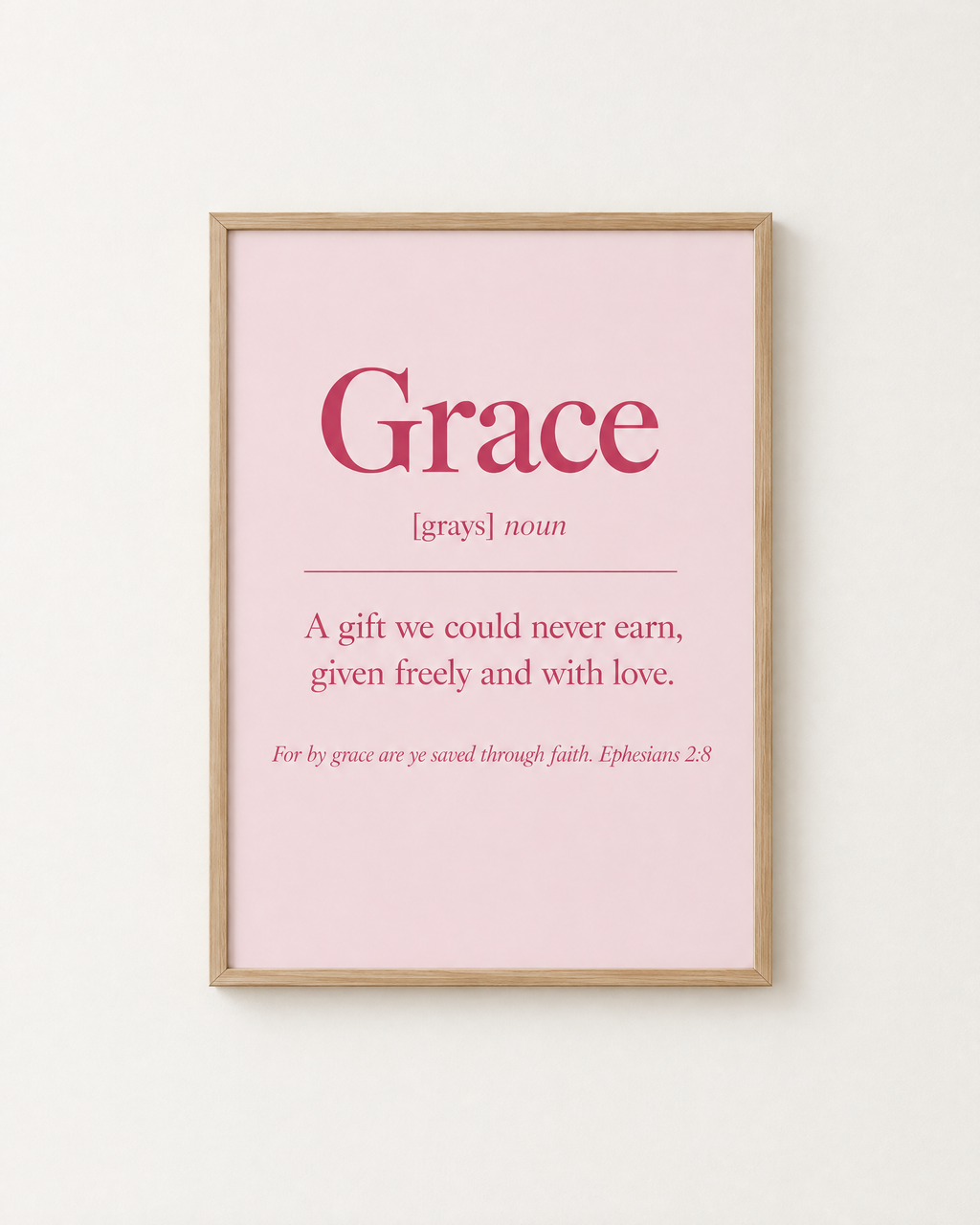 Grace: Blush print in an oak frame on a white wall, reading “For by grace are ye saved through faith” (Ephesians 2:8, KJV). Digital mockup.