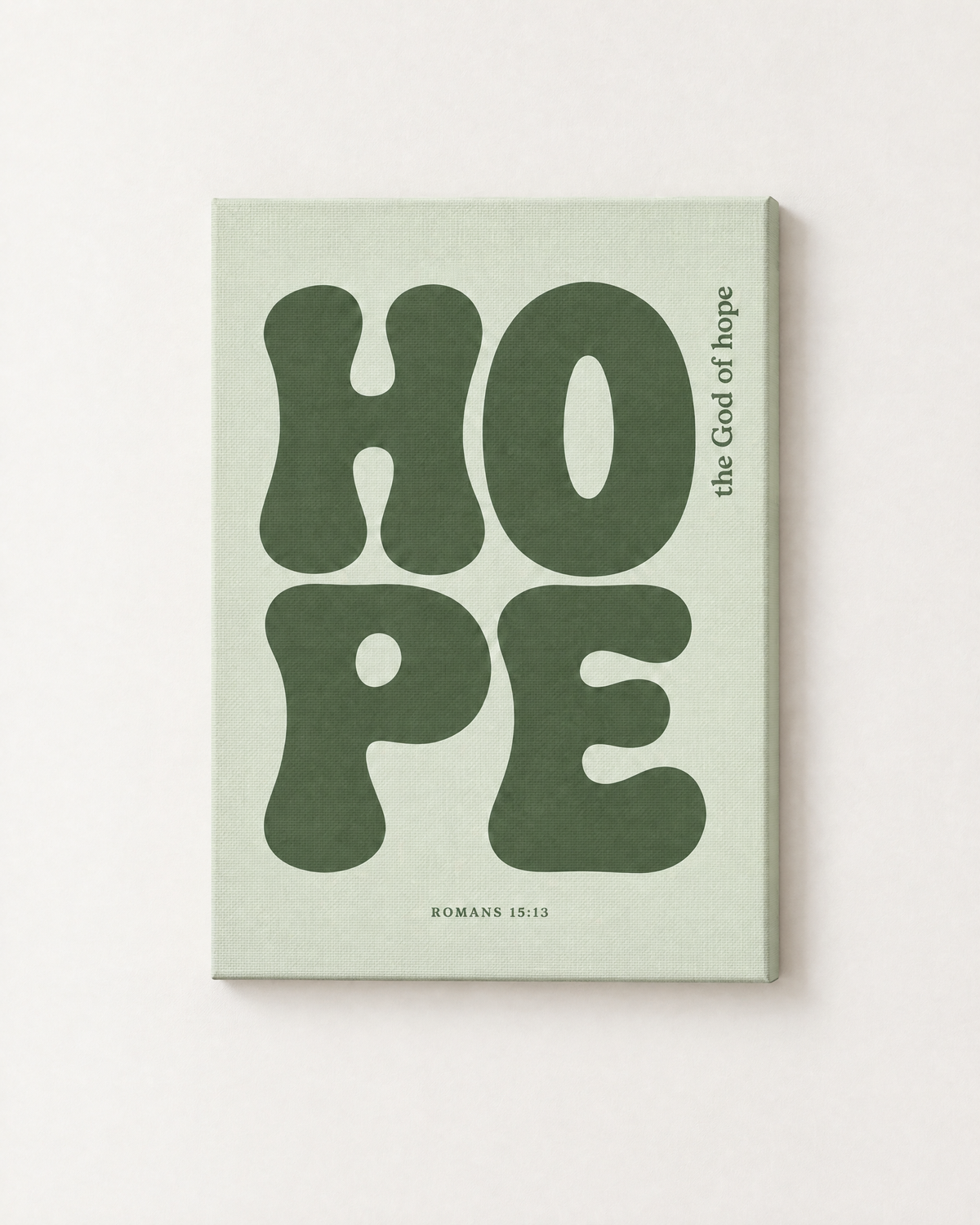 Hope: Sage print as a gallery-wrapped canvas on a white wall, reading “The God of hope” (Romans 15:13, KJV). Digital mockup.