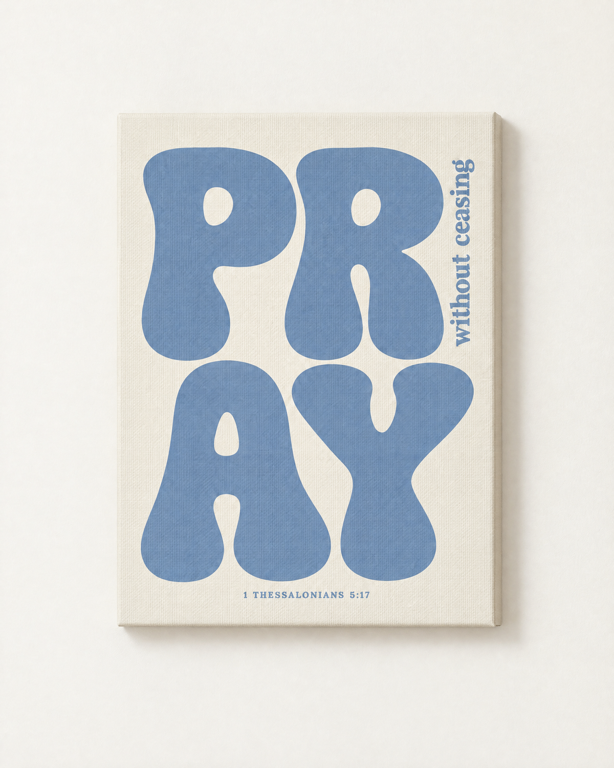 Pray: Dusty Blue print as a gallery-wrapped canvas on a white wall, reading “Pray without ceasing” (1 Thessalonians 5:17, KJV). Digital mockup.