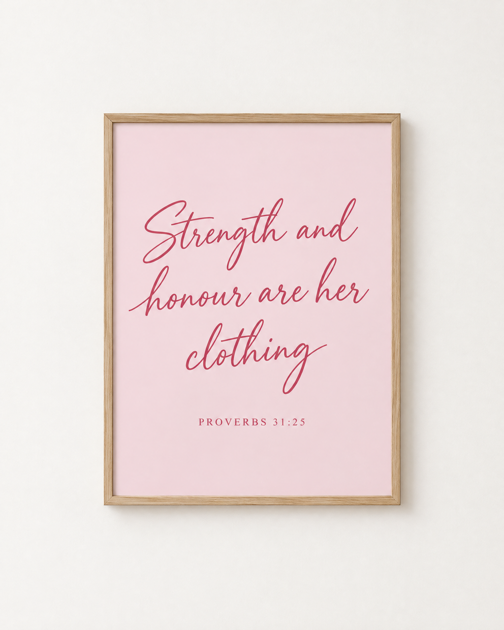Strength and Honour: Blush print in an oak frame on a white wall, reading “Strength and honour are her clothing” (Proverbs 31:25, KJV). Digital mockup.