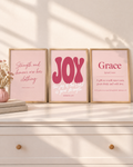 Digital mockup: the Blush Set of 3 in oak frames on a white dresser: “Strength and honour are her clothing” (Proverbs 31:25), JOY “the joy of the LORD is your strength” (Nehemiah 8:10) and Grace (Ephesians 2:8).