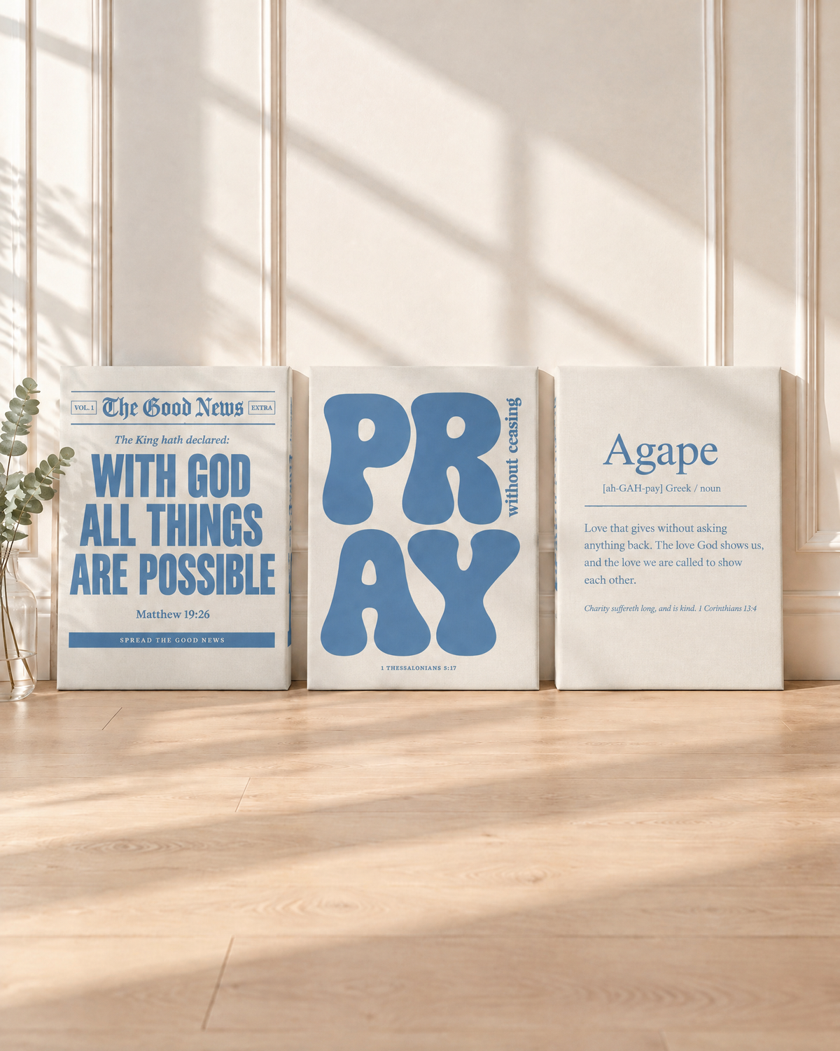 Digital mockup: the Dusty Blue Set of 3 as gallery-wrapped canvases leaning on a floor: “With God all things are possible” (Matthew 19:26), PRAY “without ceasing” (1 Thessalonians 5:17) and Agape (1 Corinthians 13:4).