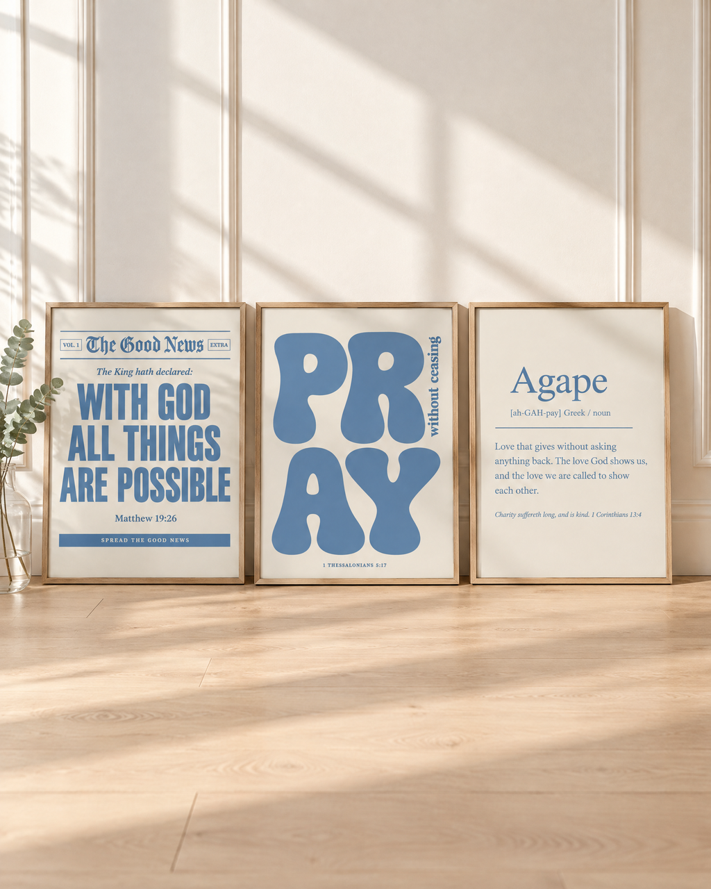 Digital mockup: the Dusty Blue Set of 3 in oak frames leaning on a floor: “With God all things are possible” (Matthew 19:26), PRAY “without ceasing” (1 Thessalonians 5:17) and Agape (1 Corinthians 13:4).