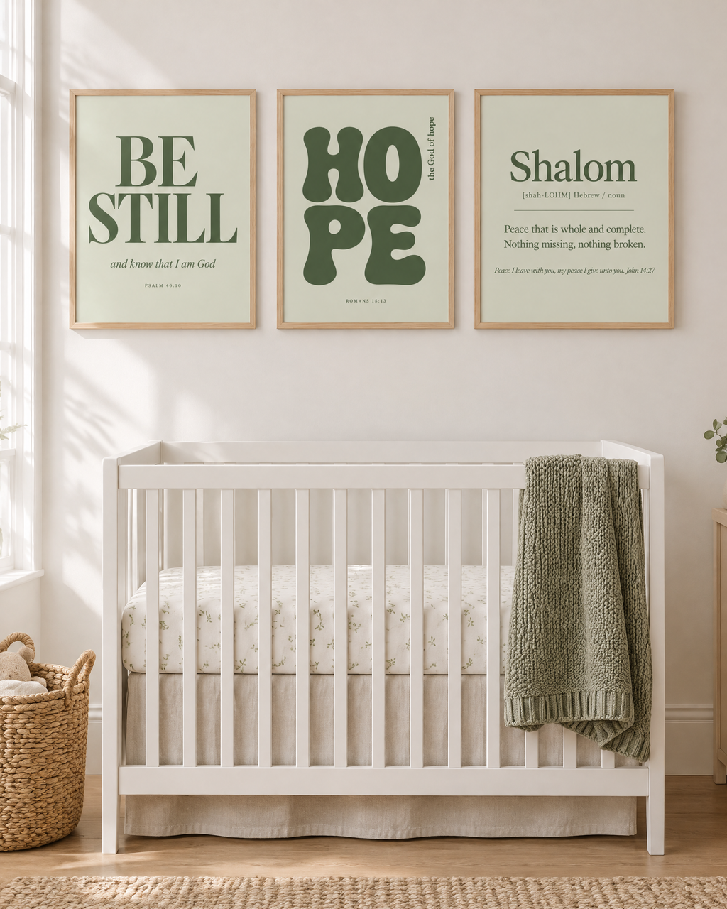 Digital mockup: the Sage Set of 3 in oak frames above a crib: BE STILL “and know that I am God” (Psalm 46:10), HOPE “the God of hope” (Romans 15:13) and Shalom (John 14:27).