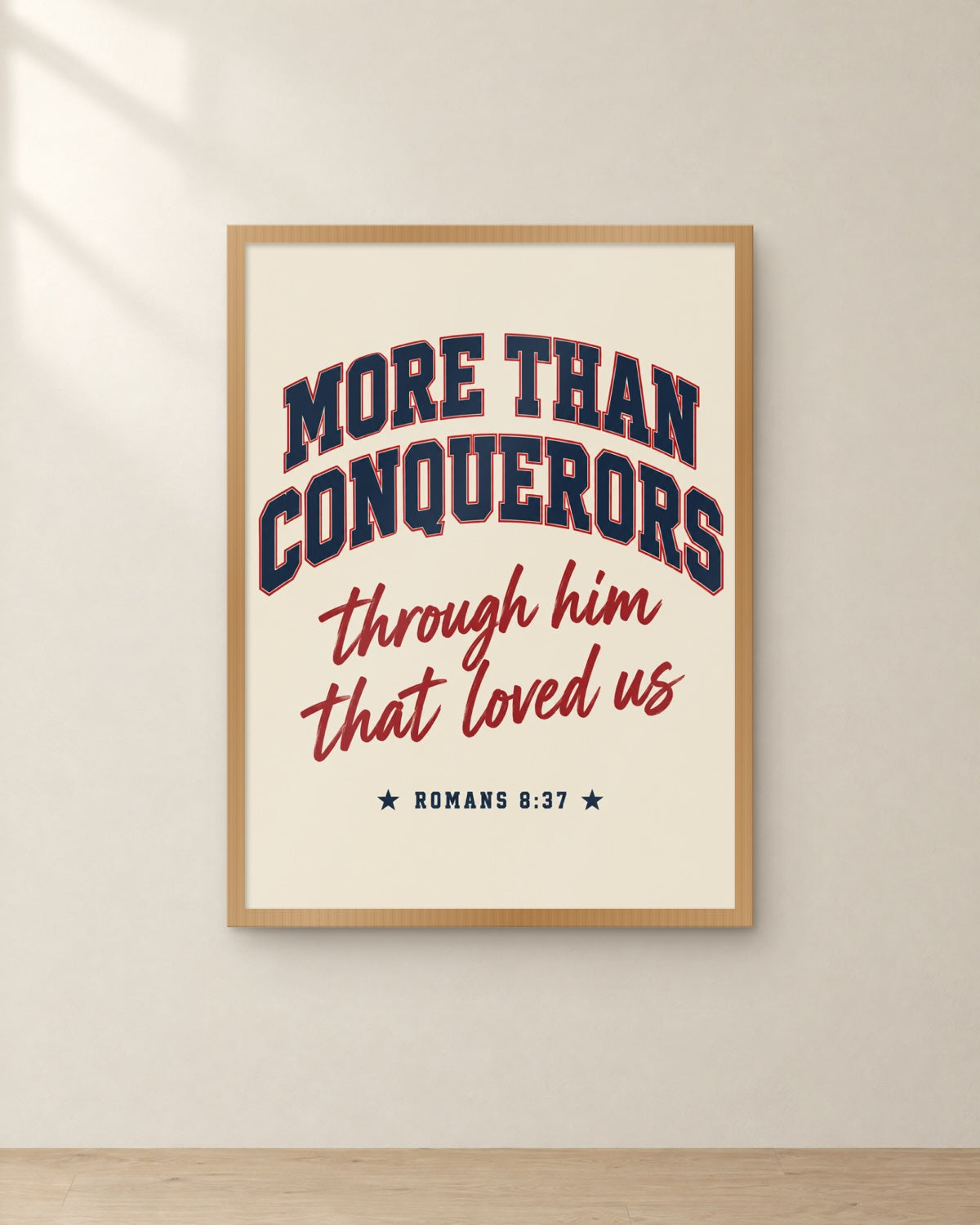 More Than Conquerors, Romans 8:37, framed in oak. Digital mockup.